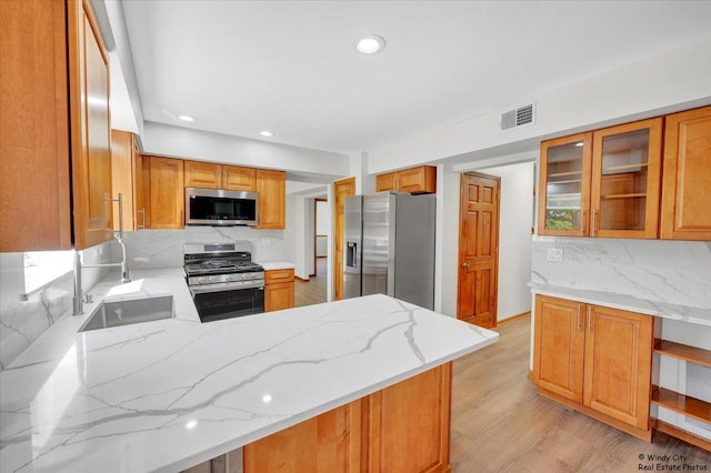 590 Woodcrest Ct, Carol Stream, IL 60188 - kitchen with stainless steel appliances, backsplash, light stone countertops, a peninsula, and recessed lighting
