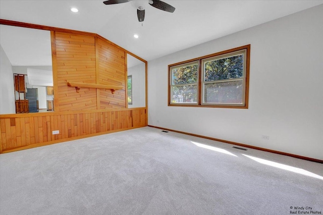 590 Woodcrest Ct, Carol Stream, IL 60188 - spare room with lofted ceiling, carpet flooring, wood walls, recessed lighting, and ceiling fan