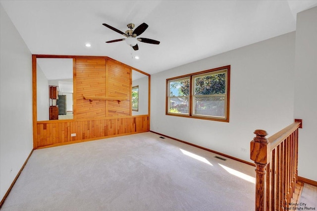 590 Woodcrest Ct, Carol Stream, IL 60188 - unfurnished living room with ceiling fan, recessed lighting, lofted ceiling, wooden walls, and carpet flooring