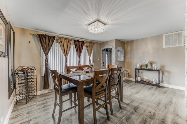 7740 Monitor Ave, Burbank, IL 60459 - dining area with light wood finished floors and a chandelier