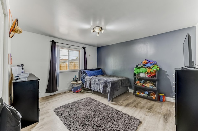 7740 Monitor Ave, Burbank, IL 60459 - bedroom with light wood-style flooring and baseboards