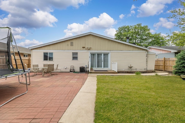 7740 Monitor Ave, Burbank, IL 60459 - rear view of house with a trampoline, a patio area, and french doors