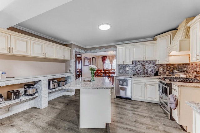 7740 Monitor Ave, Burbank, IL 60459 - kitchen featuring appliances with stainless steel finishes, ornamental molding, light stone countertops, light wood-type flooring, and backsplash