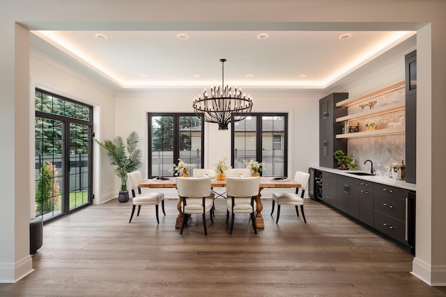 1847 Dexter Ln, Des Plaines, IL 60018 - dining area featuring a chandelier, wood finished floors, and a raised ceiling