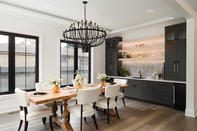 1847 Dexter Ln, Des Plaines, IL 60018 - dining area with bar with sink, dark wood-style flooring, a chandelier, recessed lighting, and a raised ceiling