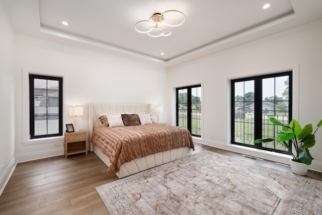 1847 Dexter Ln, Des Plaines, IL 60018 - bedroom featuring a raised ceiling, wood finished floors, recessed lighting, and a chandelier