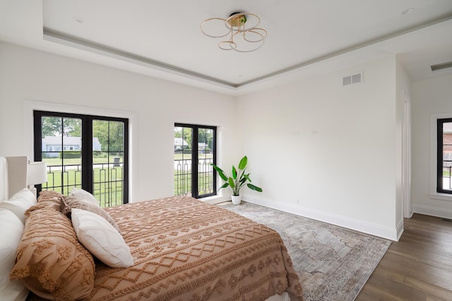 1847 Dexter Ln, Des Plaines, IL 60018 - bedroom featuring access to outside, a tray ceiling, and wood finished floors