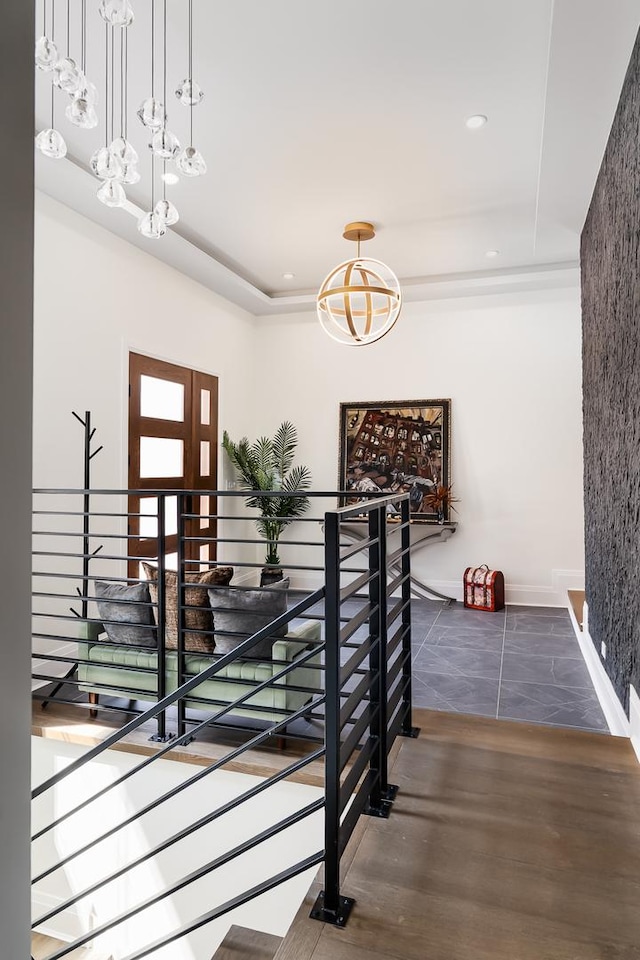 1847 Dexter Ln, Des Plaines, IL 60018 - staircase with a chandelier, a raised ceiling, and recessed lighting