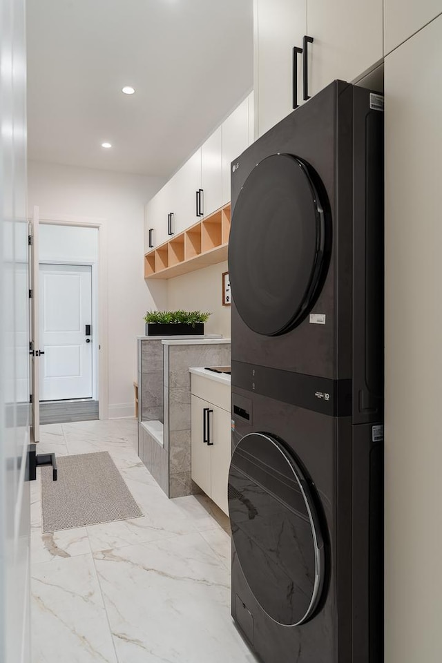 1847 Dexter Ln, Des Plaines, IL 60018 - laundry room featuring stacked washer and clothes dryer, recessed lighting, and light marble finish flooring