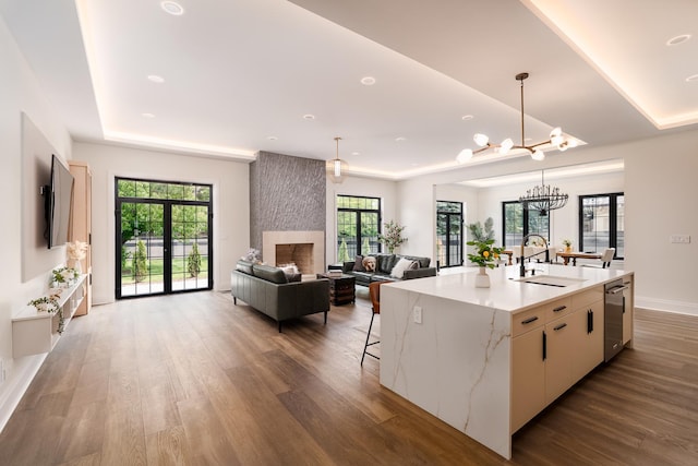 1847 Dexter Ln, Des Plaines, IL 60018 - kitchen with stainless steel dishwasher, wood finished floors, a chandelier, pendant lighting, and a center island with sink