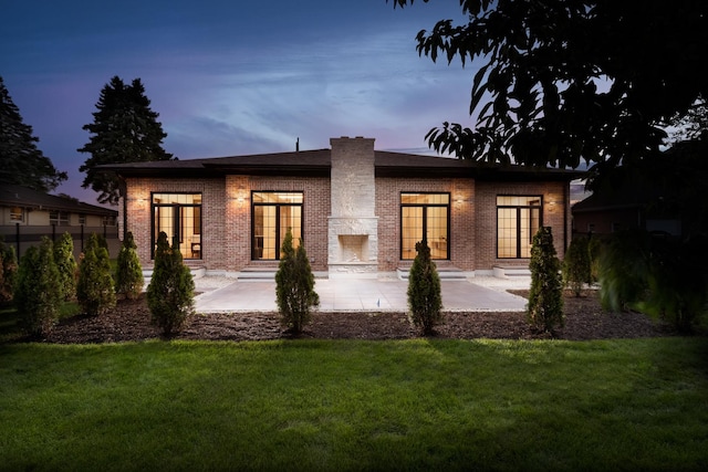 1847 Dexter Ln, Des Plaines, IL 60018 - back of property with a yard, brick siding, a patio, entry steps, and a chimney