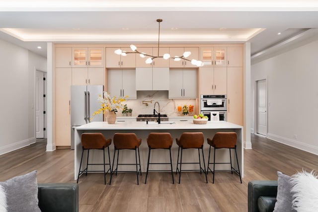 1847 Dexter Ln, Des Plaines, IL 60018 - kitchen with stainless steel double oven, high quality fridge, light countertops, wood finished floors, and recessed lighting