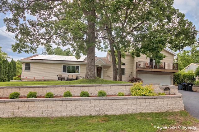 702 W Broadway St, Mchenry, IL 60051 - view of front facade featuring a garage, roof mounted solar panels, asphalt driveway, a front lawn, and a deck