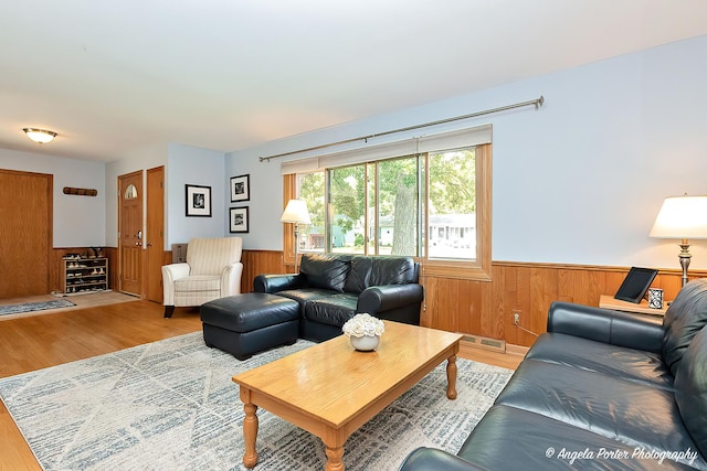 702 W Broadway St, Mchenry, IL 60051 - living room featuring wainscoting, wood finished floors, and wood walls