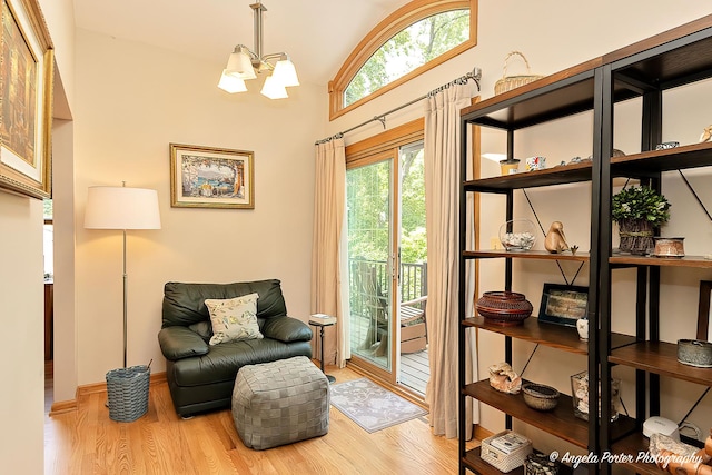 702 W Broadway St, Mchenry, IL 60051 - living area featuring wood finished floors, a chandelier, and high vaulted ceiling