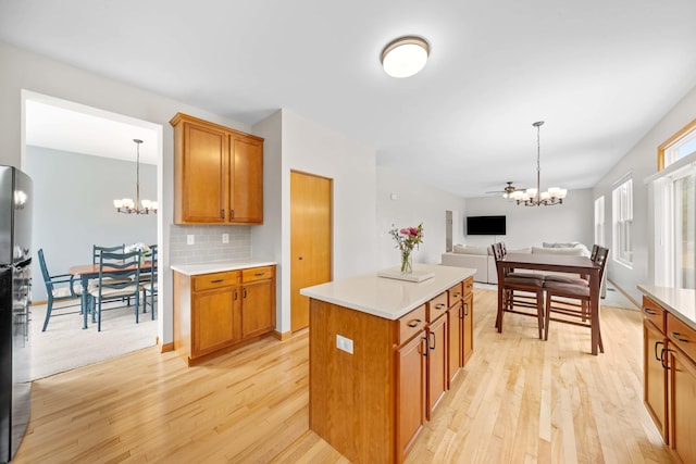 4553 Gardiner Ave, Yorkville, IL 60560 - kitchen with a chandelier, light wood-style floors, and brown cabinets