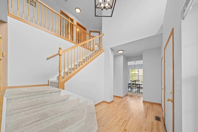 4553 Gardiner Ave, Yorkville, IL 60560 - entryway with a chandelier, wood-type flooring, stairs, a towering ceiling, and recessed lighting