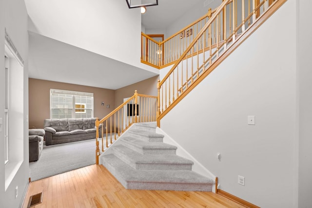 4553 Gardiner Ave, Yorkville, IL 60560 - stairway with hardwood / wood-style flooring and a towering ceiling