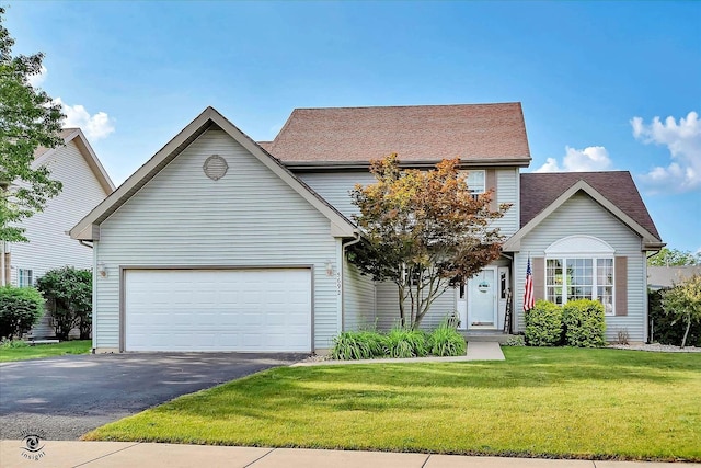 5692 W Roosevelt St, Monee, IL 60449 - traditional home with driveway, a front lawn, and a garage