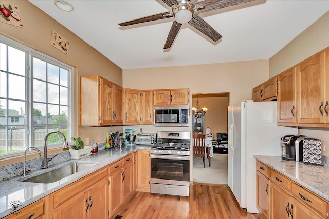 5692 W Roosevelt St, Monee, IL 60449 - kitchen with appliances with stainless steel finishes, ceiling fan, light stone countertops, and light wood finished floors