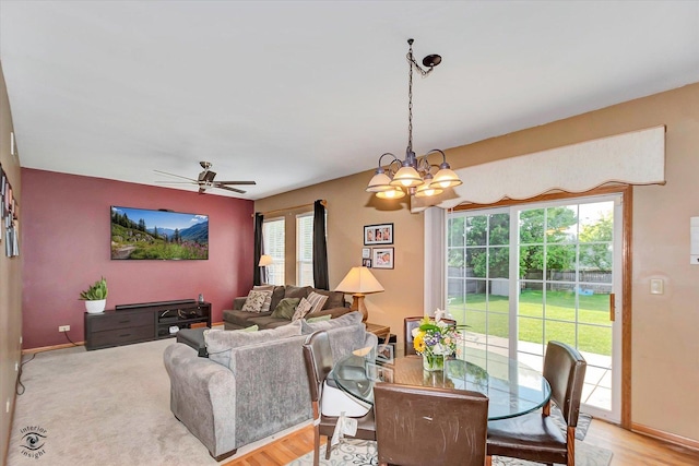 5692 W Roosevelt St, Monee, IL 60449 - dining space featuring a chandelier, a ceiling fan, and light wood-style flooring