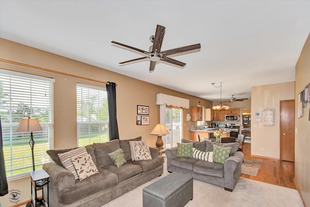 5692 W Roosevelt St, Monee, IL 60449 - living room with ceiling fan, light wood-type flooring, and a chandelier