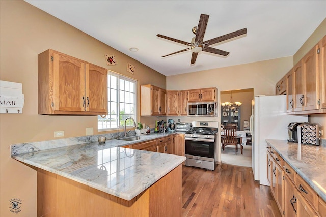 5692 W Roosevelt St, Monee, IL 60449 - kitchen with stainless steel appliances, a peninsula, a ceiling fan, wood finished floors, and light stone counters