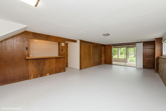 4321 Bay View Dr, Crystal Lake, IL 60014 - unfurnished living room with wood walls and concrete flooring