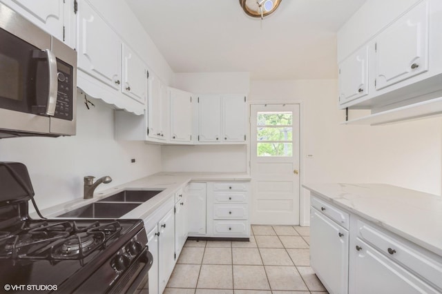 4321 Bay View Dr, Crystal Lake, IL 60014 - kitchen featuring stainless steel microwave, gas stove, white cabinetry, and light tile patterned floors