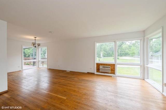 4321 Bay View Dr, Crystal Lake, IL 60014 - unfurnished room with a chandelier, light wood finished floors, and a wall unit AC