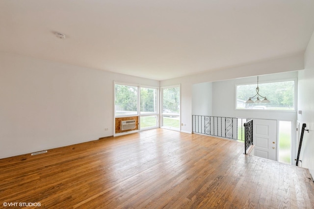 4321 Bay View Dr, Crystal Lake, IL 60014 - unfurnished room with a wall unit AC, wood finished floors, plenty of natural light, and a smoke detector