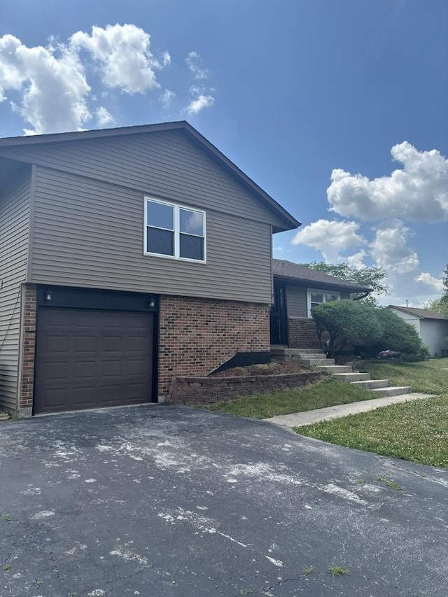 3501 Fountainbleau Dr, Hazel Crest, IL 60429 - view of side of home with brick siding, a garage, and asphalt driveway