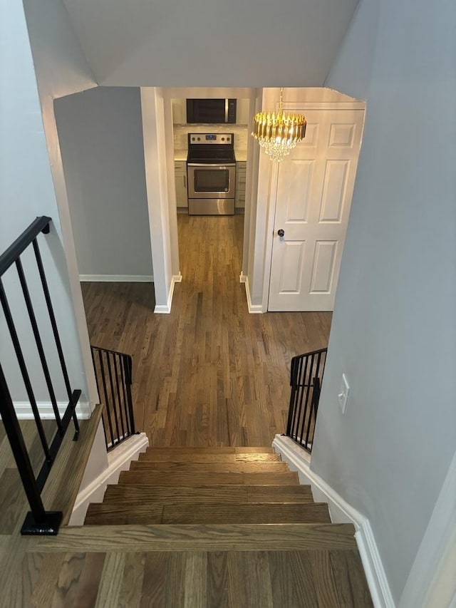 3501 Fountainbleau Dr, Hazel Crest, IL 60429 - staircase featuring a chandelier and wood finished floors