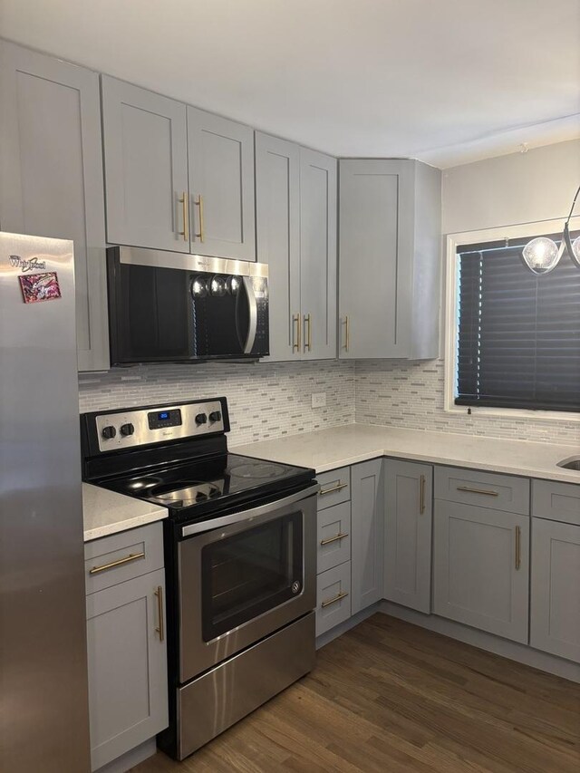 3501 Fountainbleau Dr, Hazel Crest, IL 60429 - kitchen featuring appliances with stainless steel finishes, gray cabinetry, and backsplash