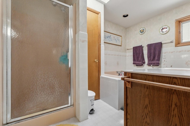 715 N 4th St, Dekalb, IL 60115 - full bathroom with a stall shower, vanity, a bath, tile patterned floors, and tile walls