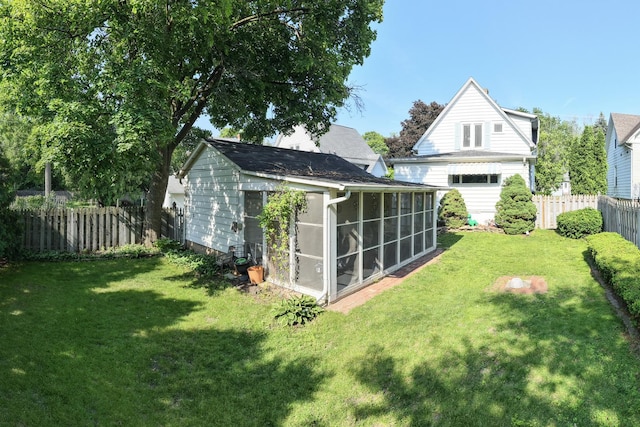 715 N 4th St, Dekalb, IL 60115 - rear view of house with a fenced backyard and a sunroom