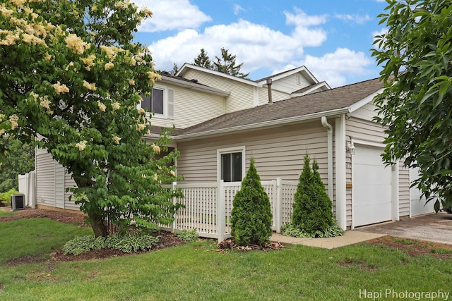 627 Bayview Pt, Schaumburg, IL 60194 - view of side of home featuring a garage, a lawn, driveway, and a shingled roof
