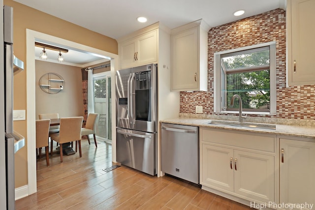 627 Bayview Pt, Schaumburg, IL 60194 - kitchen featuring appliances with stainless steel finishes, healthy amount of natural light, decorative backsplash, light stone countertops, and recessed lighting