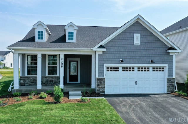 2308 Lawlor Ln, Naperville, IL 60564 - view of front of home with stone siding, asphalt driveway, a front lawn, a porch, and roof with shingles