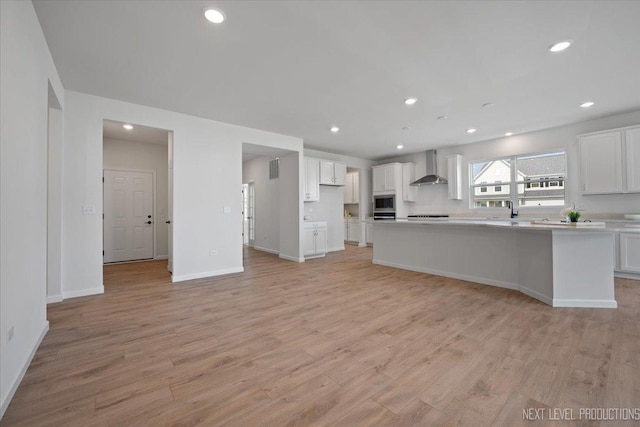 2308 Lawlor Ln, Naperville, IL 60564 - kitchen featuring wall chimney exhaust hood, white cabinets, light wood finished floors, light countertops, and recessed lighting