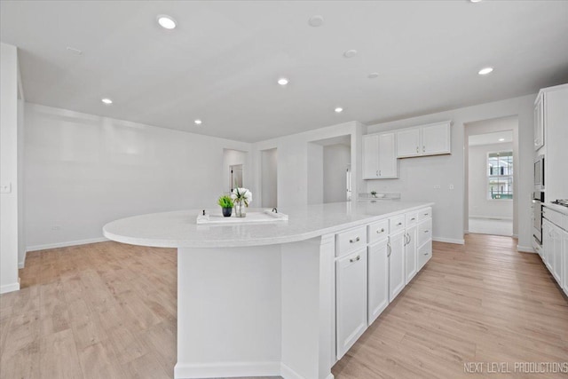 2308 Lawlor Ln, Naperville, IL 60564 - kitchen with white cabinetry, light wood-style flooring, a spacious island, and recessed lighting