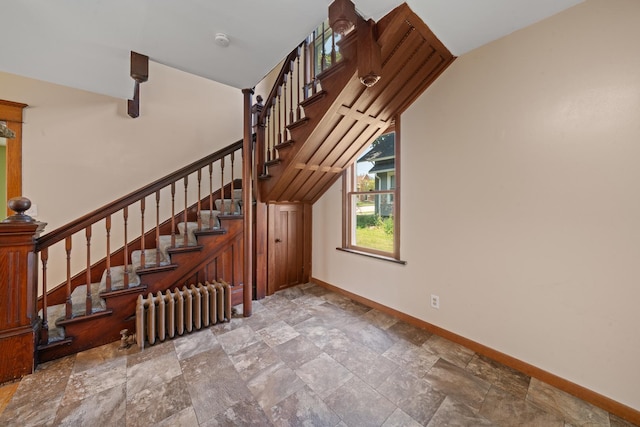 220 N Cedar St, Waterman, IL 60556 - staircase featuring radiator heating unit, stone finish flooring, and vaulted ceiling