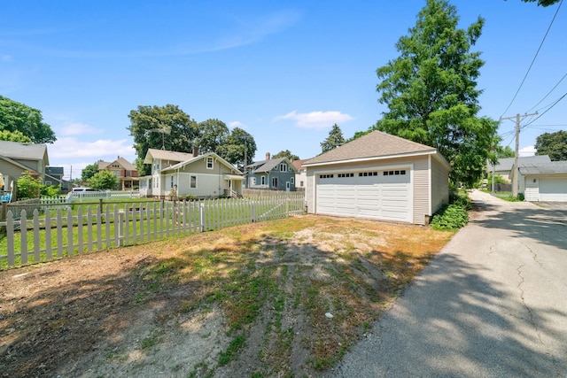 220 N Cedar St, Waterman, IL 60556 - view of yard with a garage and a residential view