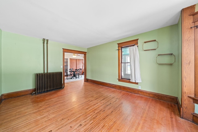 220 N Cedar St, Waterman, IL 60556 - empty room featuring radiator and wood finished floors