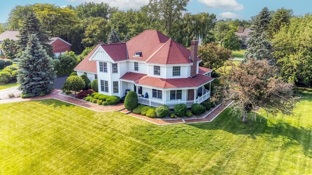 26 Carriage House Ln, Orland Park, IL 60467 - view of front of property with a chimney, a front yard, a tiled roof, and view of wooded area