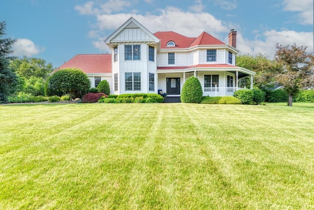 26 Carriage House Ln, Orland Park, IL 60467 - victorian-style house featuring board and batten siding, a chimney, a porch, and a front lawn