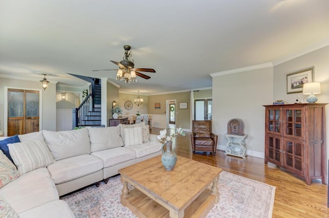 26 Carriage House Ln, Orland Park, IL 60467 - living area with stairs, ornamental molding, a ceiling fan, light wood-type flooring, and a chandelier