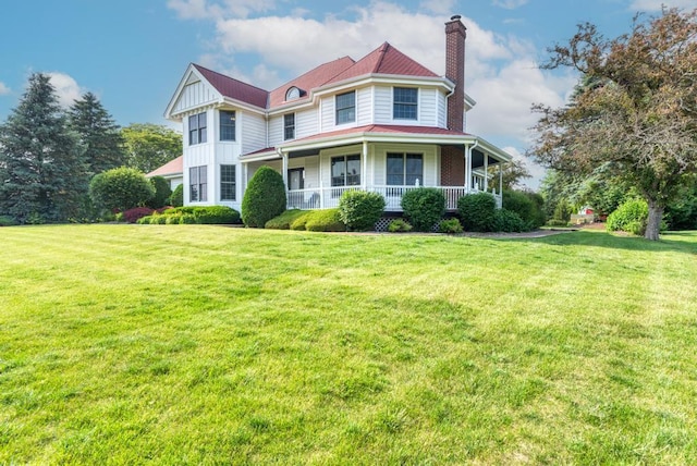 26 Carriage House Ln, Orland Park, IL 60467 - victorian home featuring a chimney, a porch, board and batten siding, and a front yard
