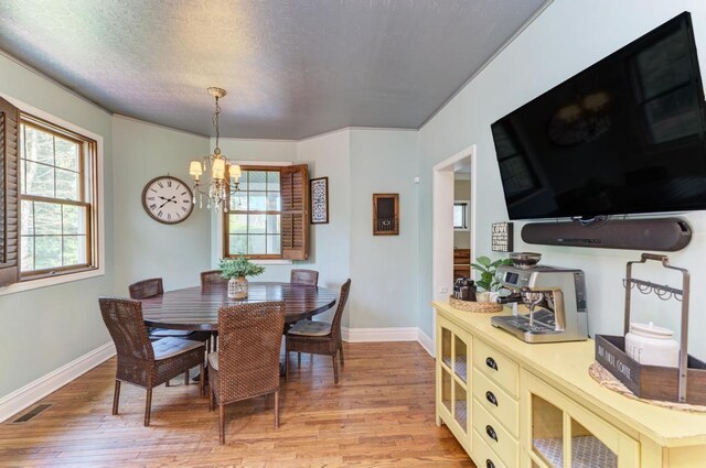 26 Carriage House Ln, Orland Park, IL 60467 - dining area with a chandelier, light wood-style flooring, and a textured ceiling