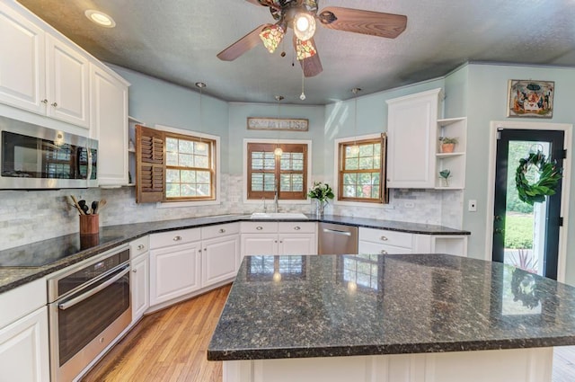 26 Carriage House Ln, Orland Park, IL 60467 - kitchen with open shelves, appliances with stainless steel finishes, light wood-style floors, white cabinetry, and ceiling fan